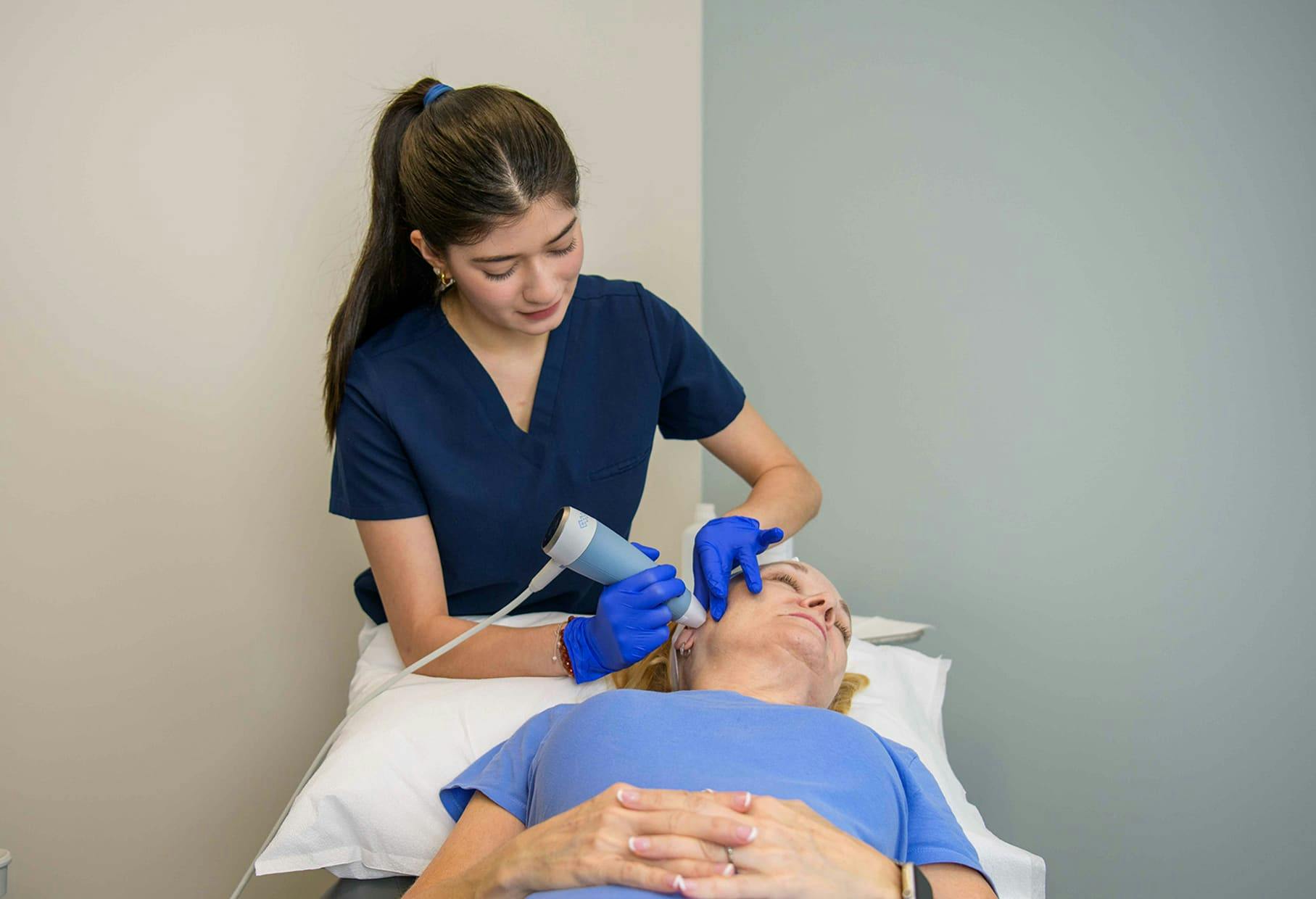 female patient geting microneedling done on her face