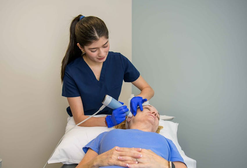 female patient geting microneedling done on her face
