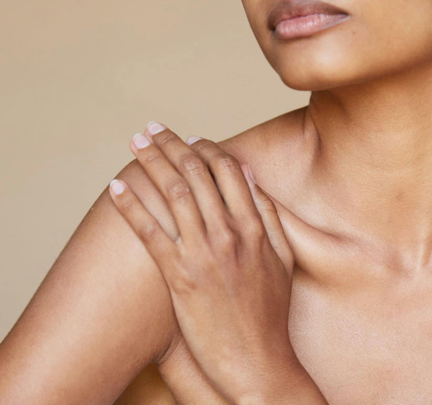 woman touching her shoulder