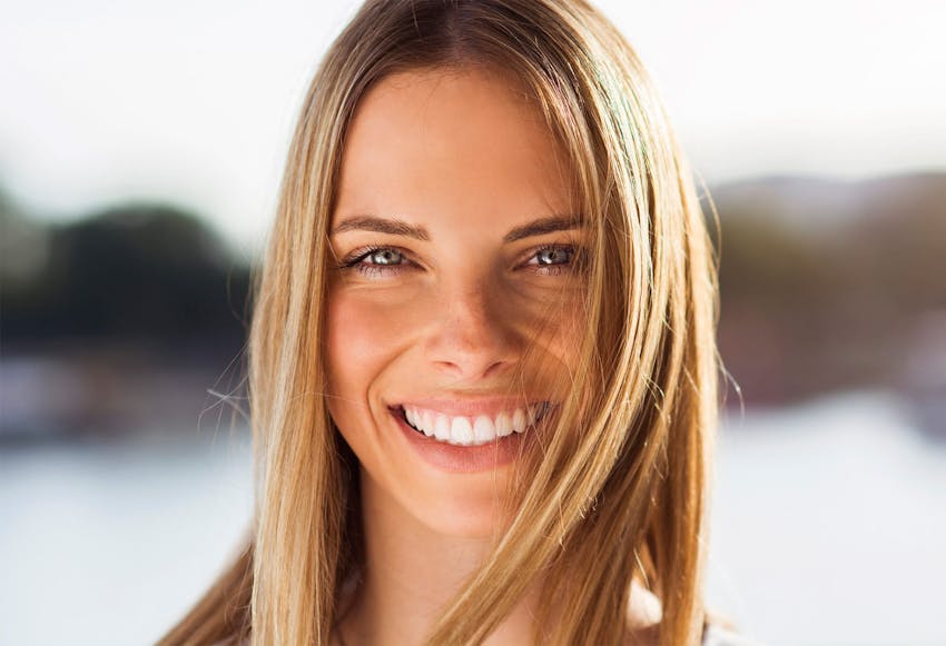 woman with long blonde hair smiling