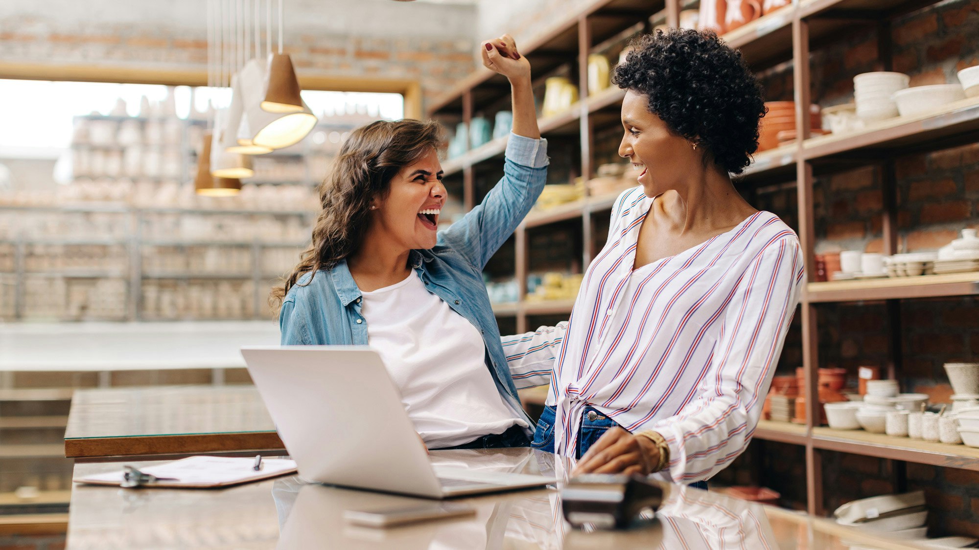 Two business women high fiving
