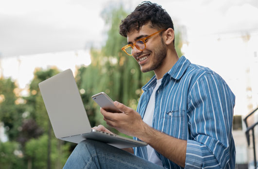 Man with laptop and cell phone