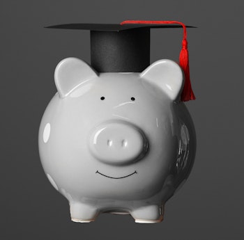 Piggy bank with college graduate cap