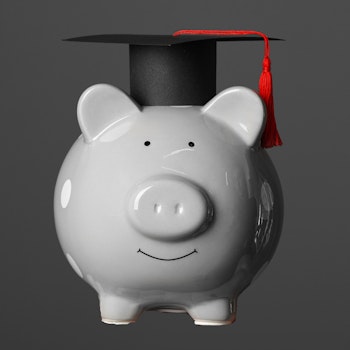 Piggy bank with college graduate cap
