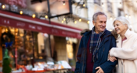 Senior couple walking along a market street