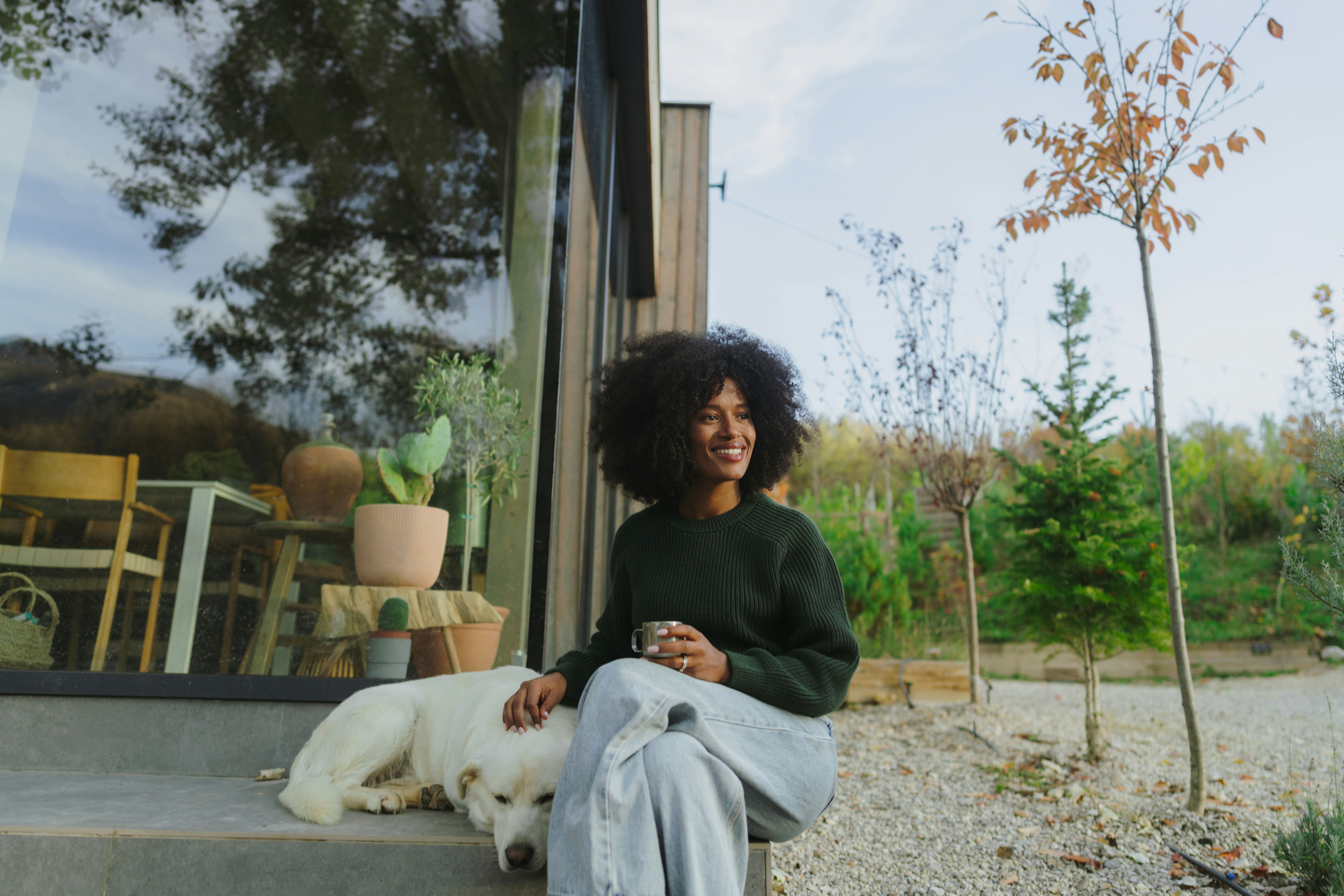 Woman sitting outside with a dog.