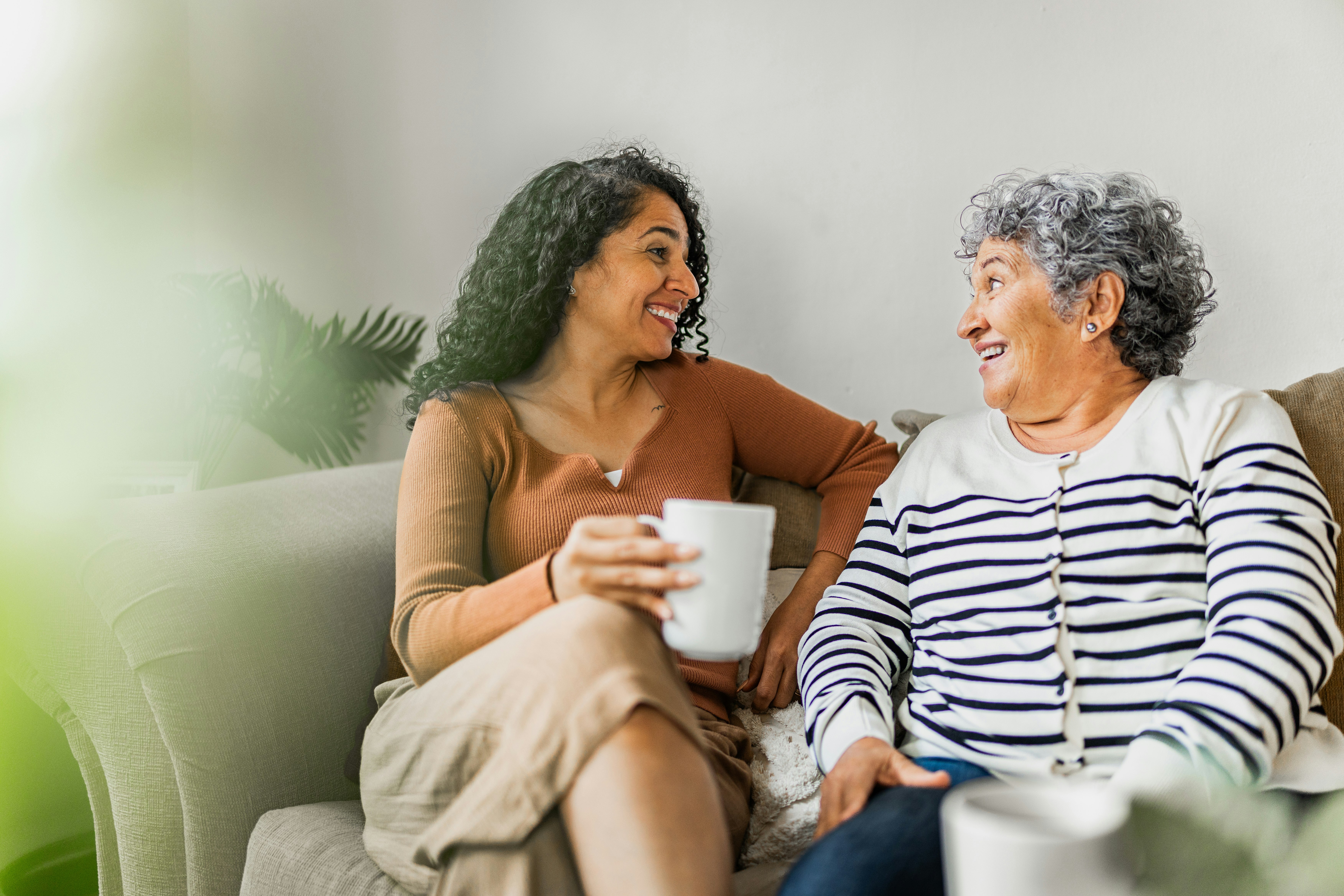 mother and daughter sitting on couch