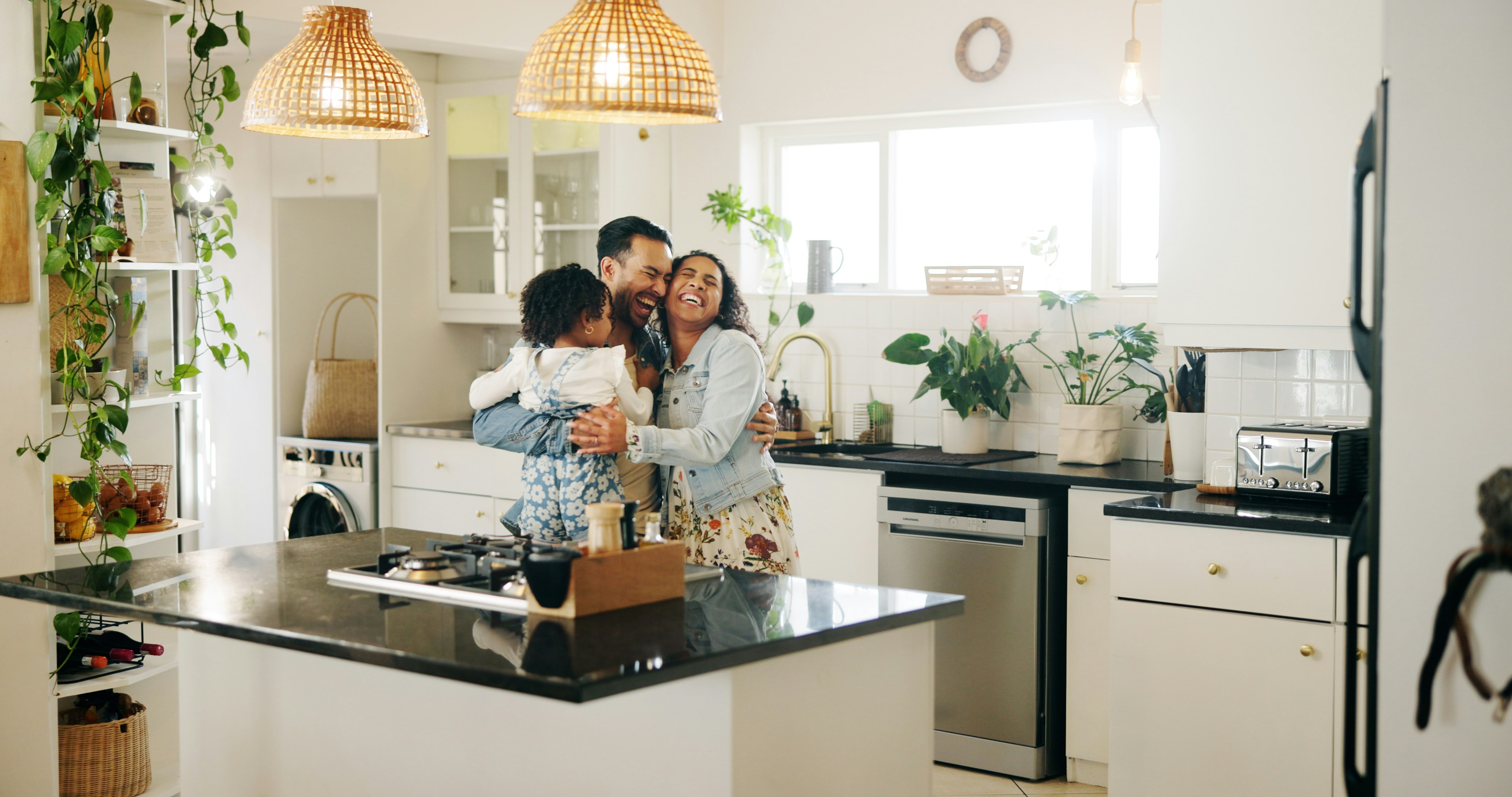 family standing in their kitchen