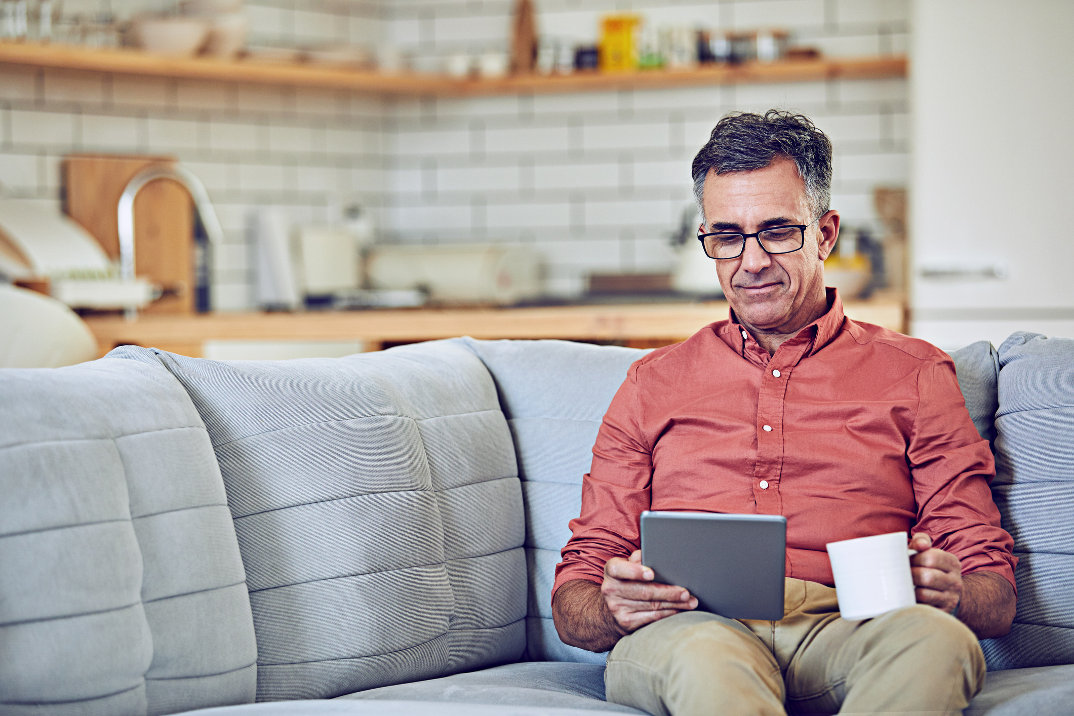 Man on couch investing