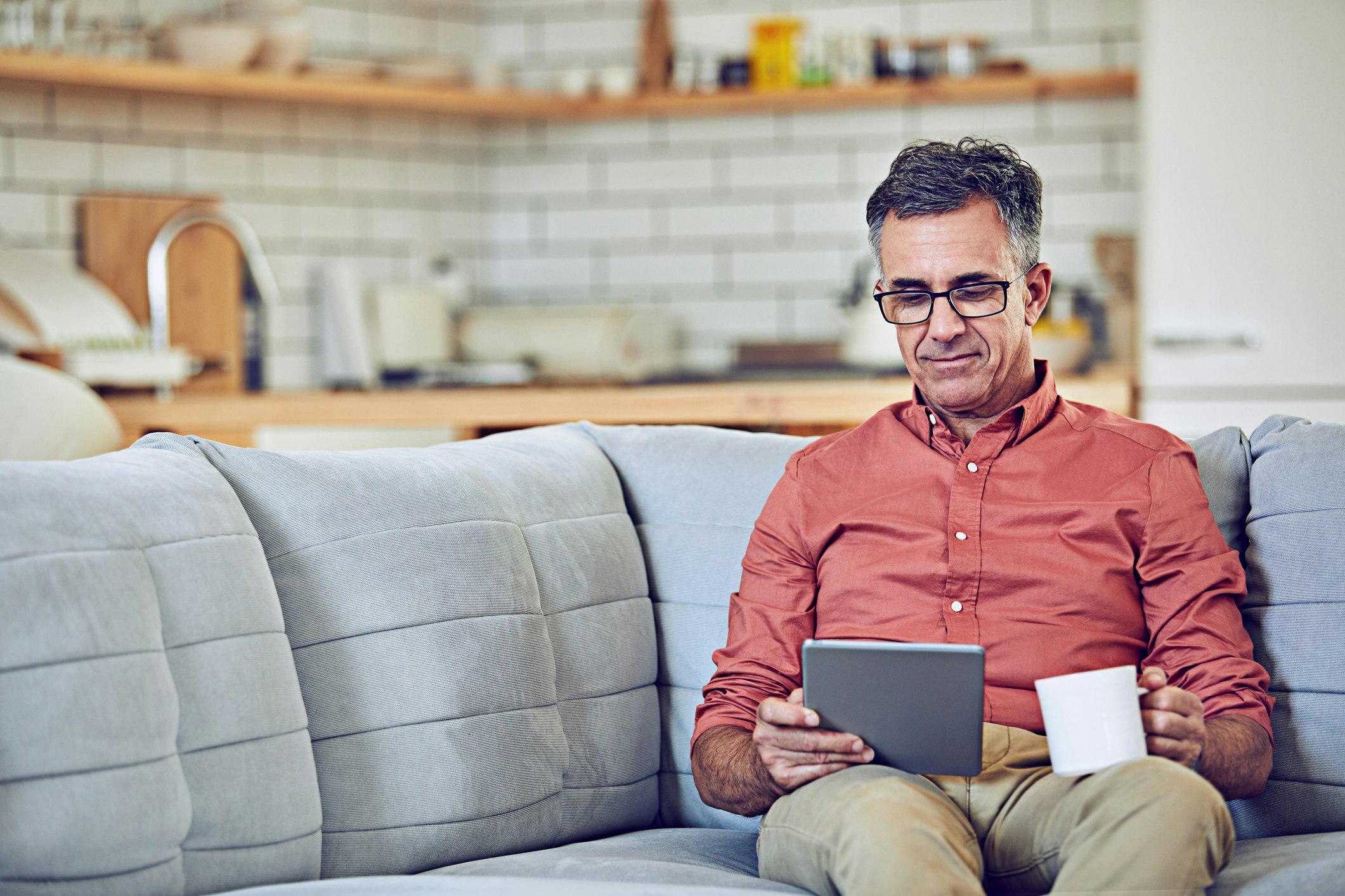 Man on couch investing