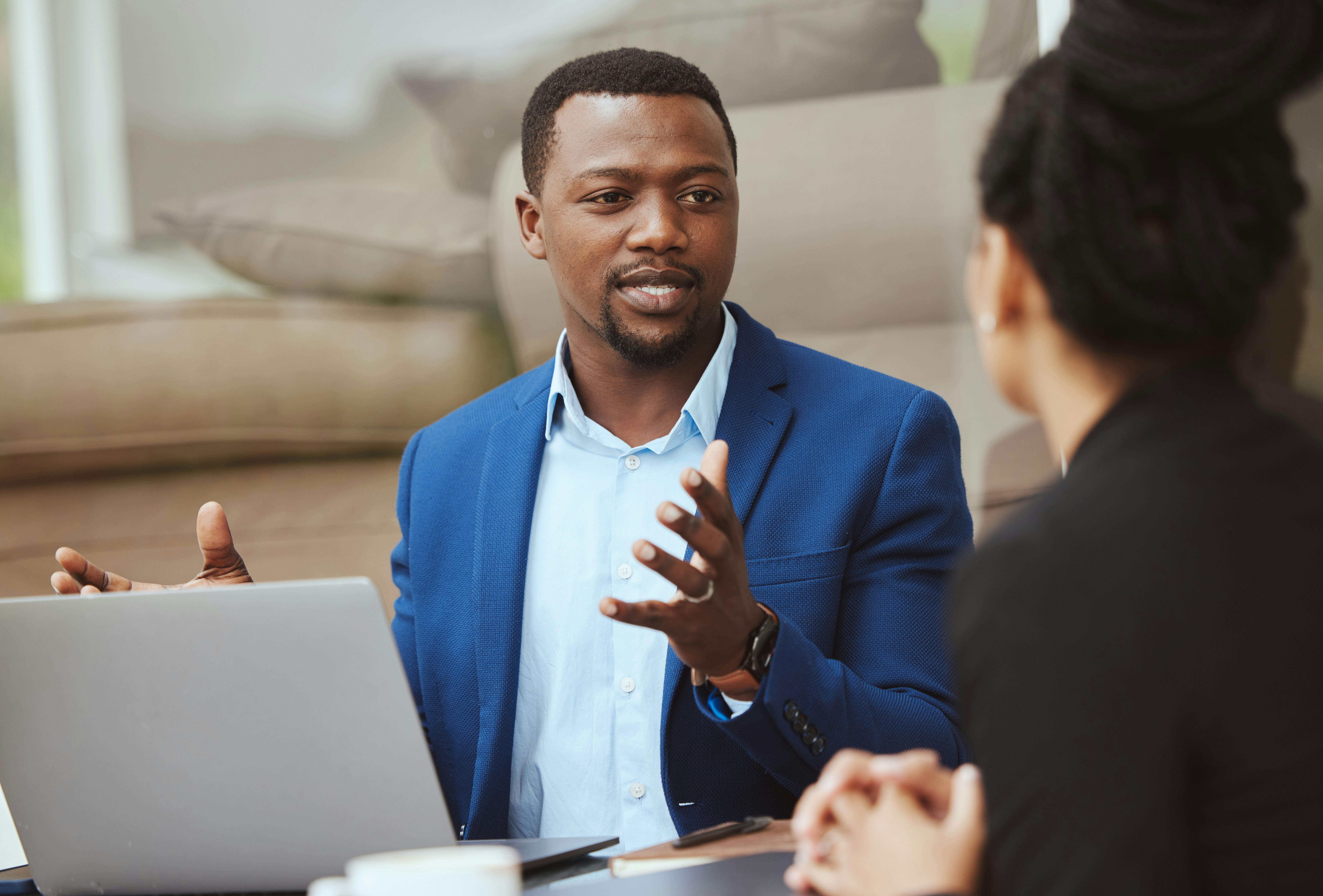 Man in boardroom talking to colleagues