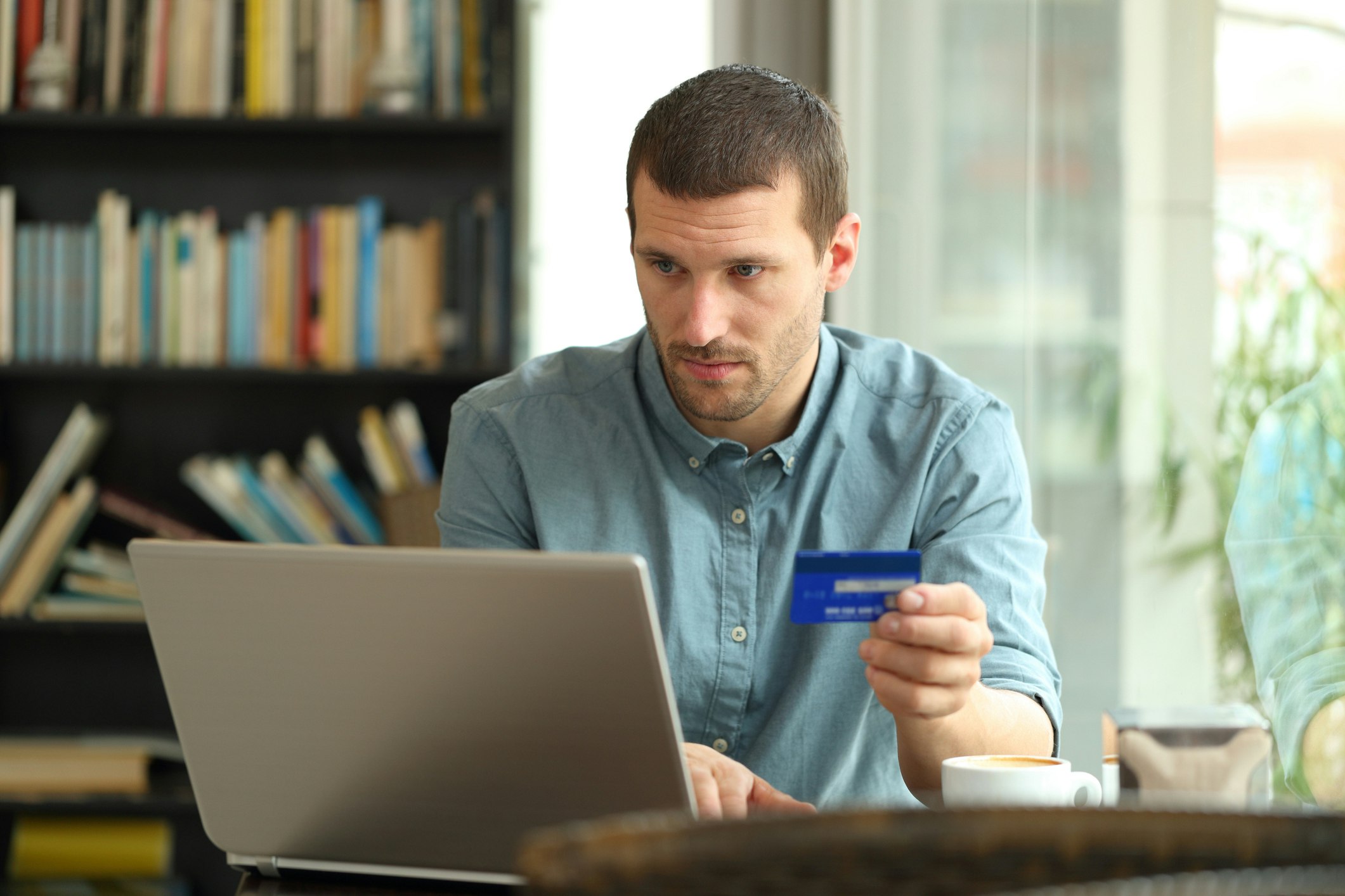 Man with credit card at computer