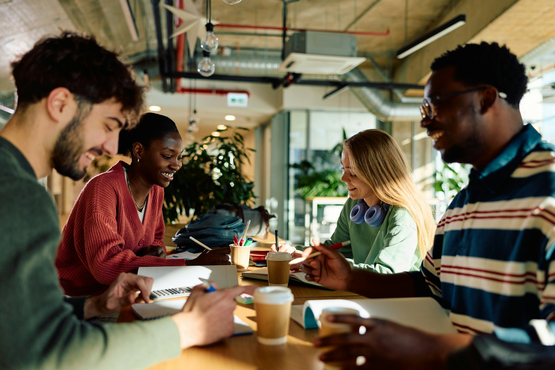 Diverse students collaborating on study project in university library