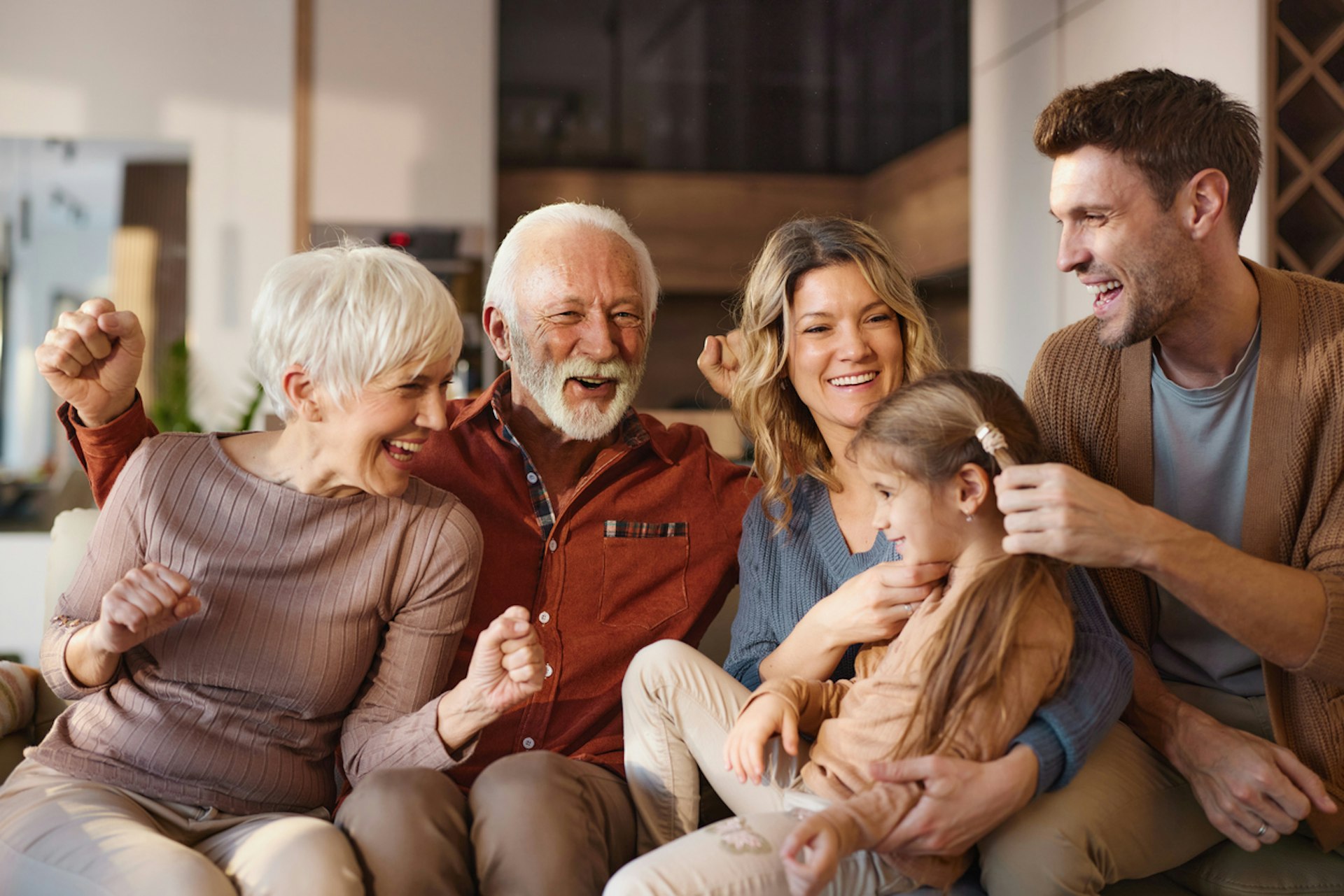 Cheerful multi-generation family having fun during their time in the living room.