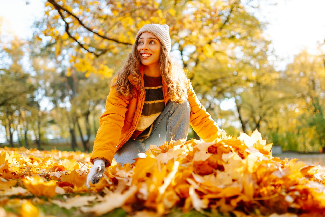 Child playing in leaves outside.