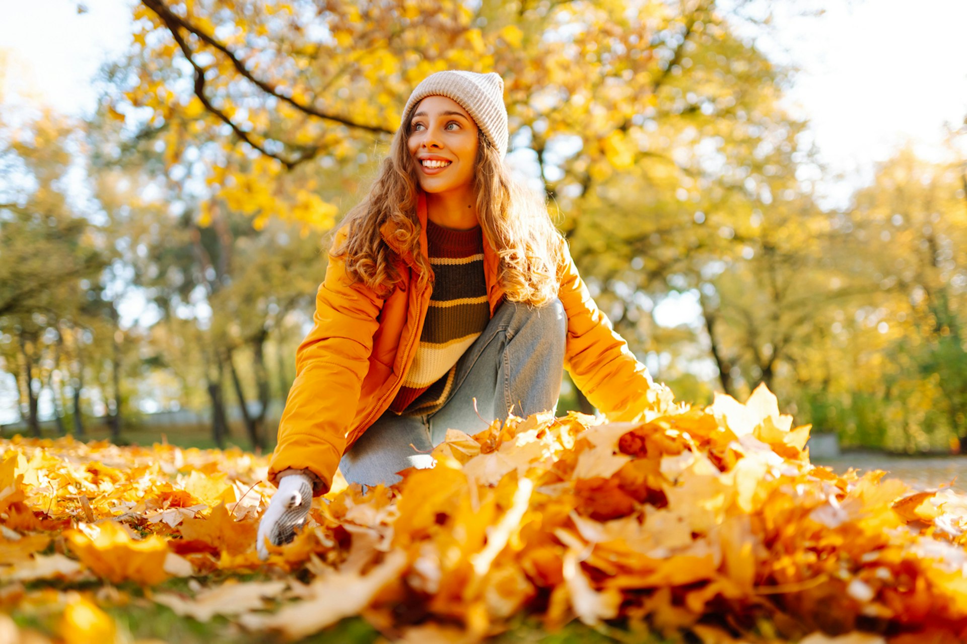 Child playing in leaves outside.