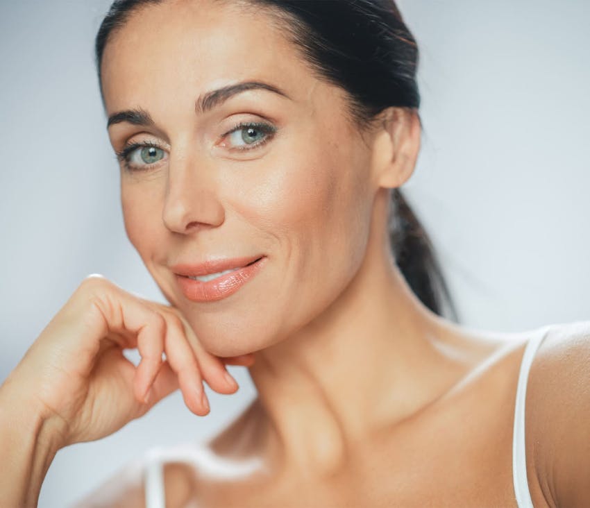 Woman smiling and touching chin