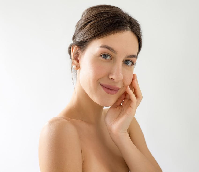 Woman smiling with hand on face