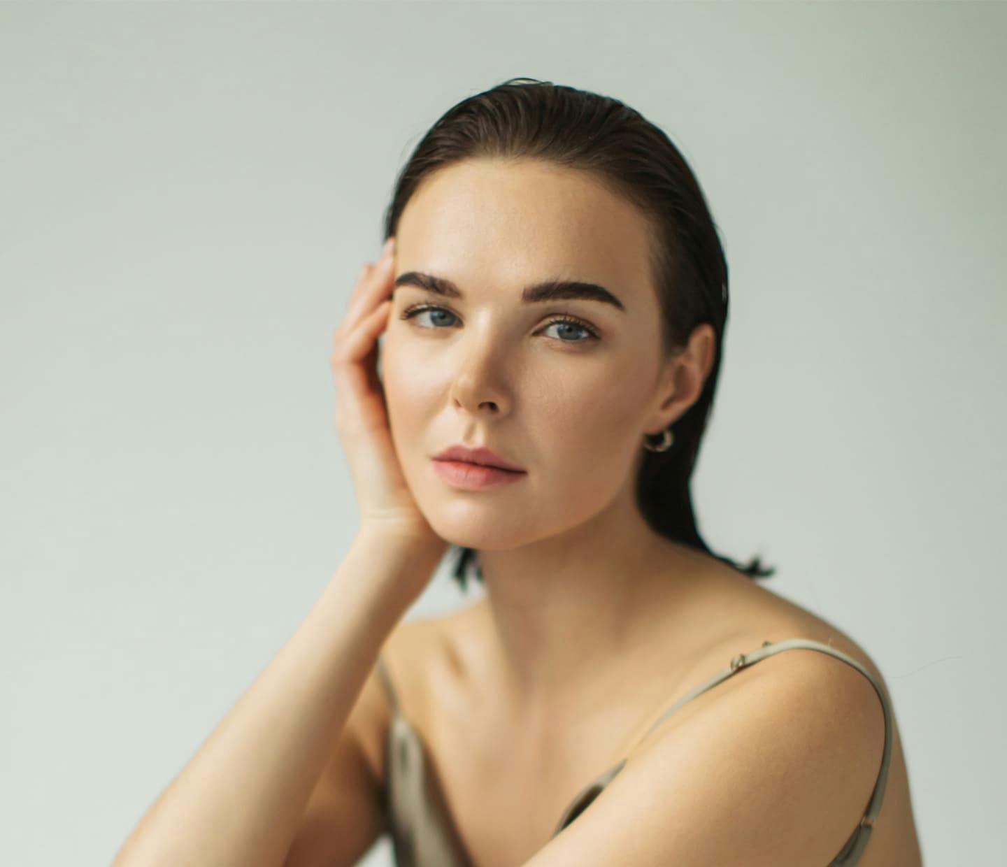 Woman with hand on face