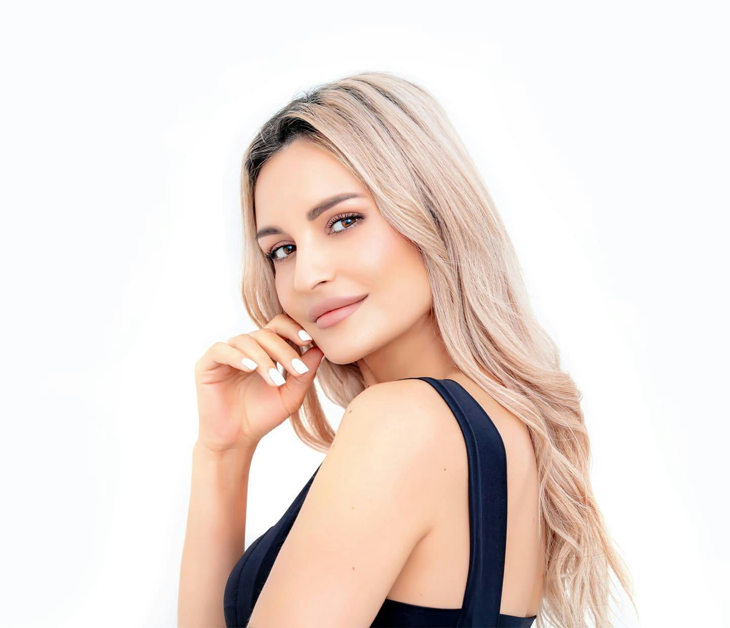 Woman smiling with hand on cheek