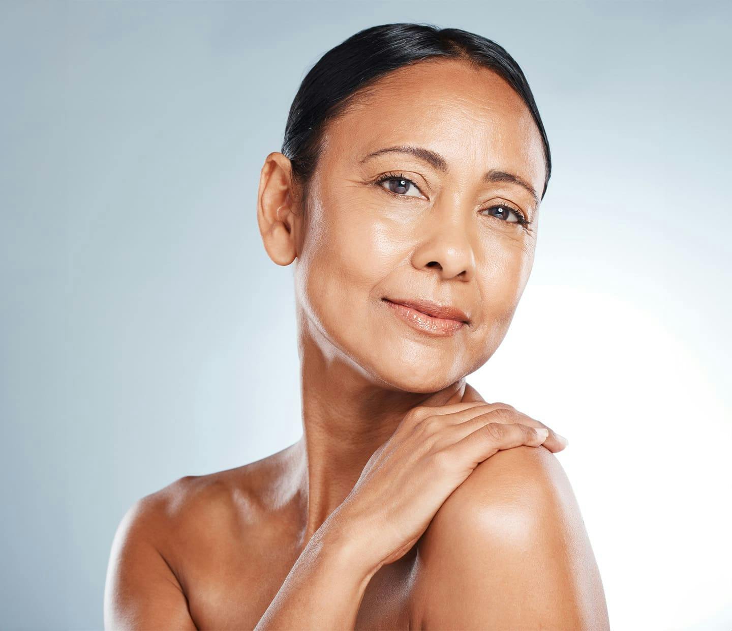 Woman smiling touching shoulder