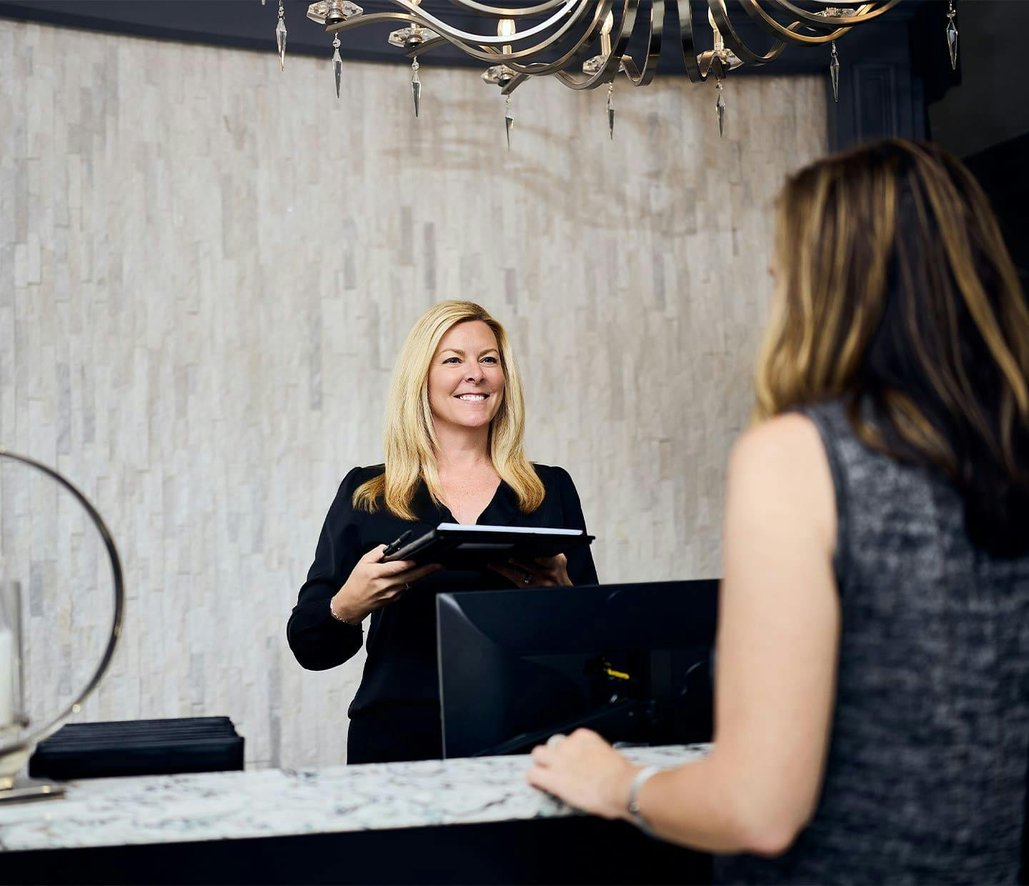 Woman smiling behind front desk