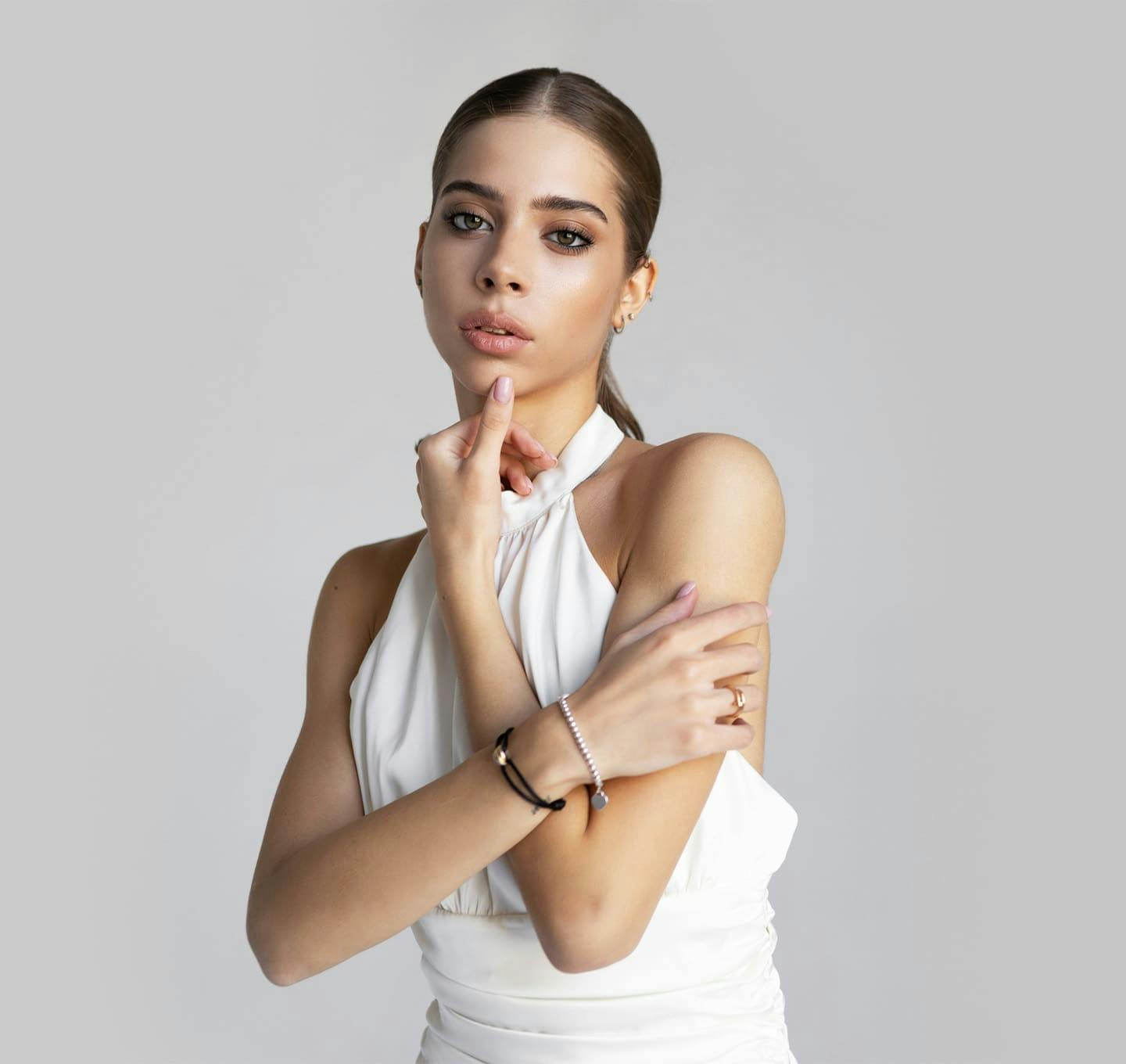 Woman with thumb on chin