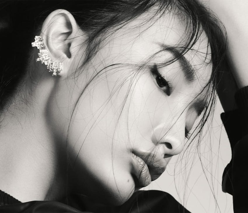 Woman smiling with hand on cheek