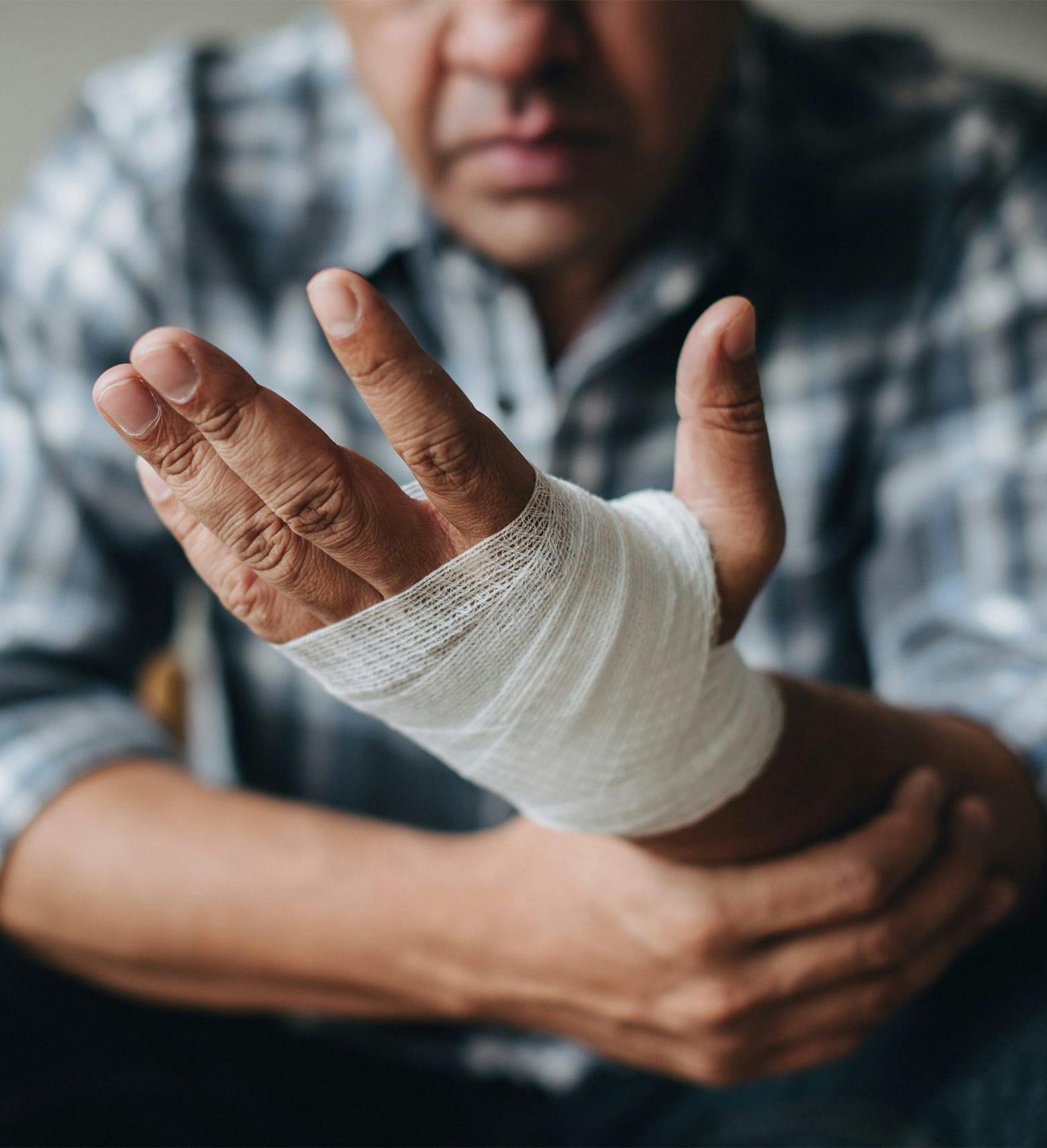 person with a hand wrapped in gauze