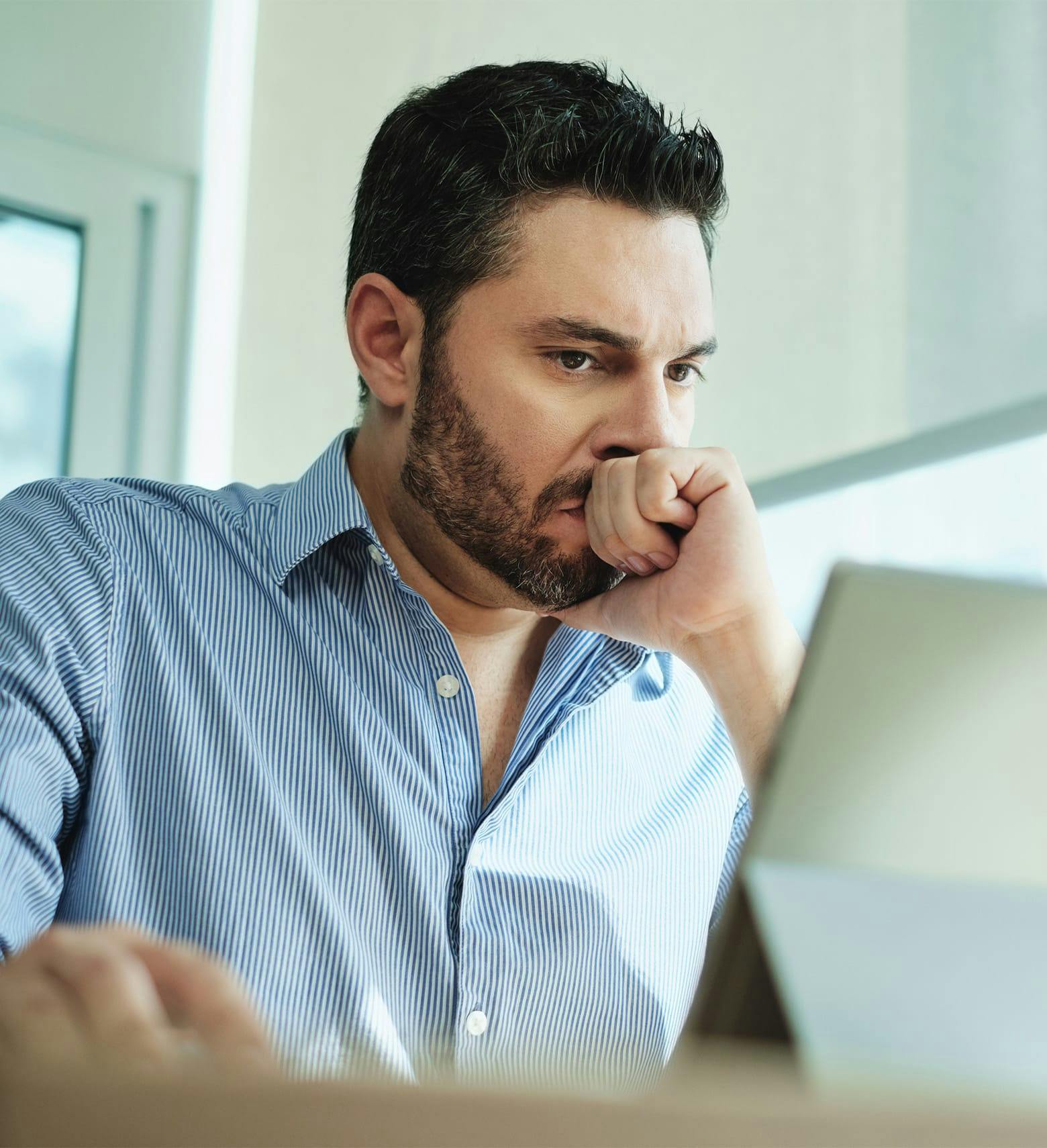 upset person looking at a tablet