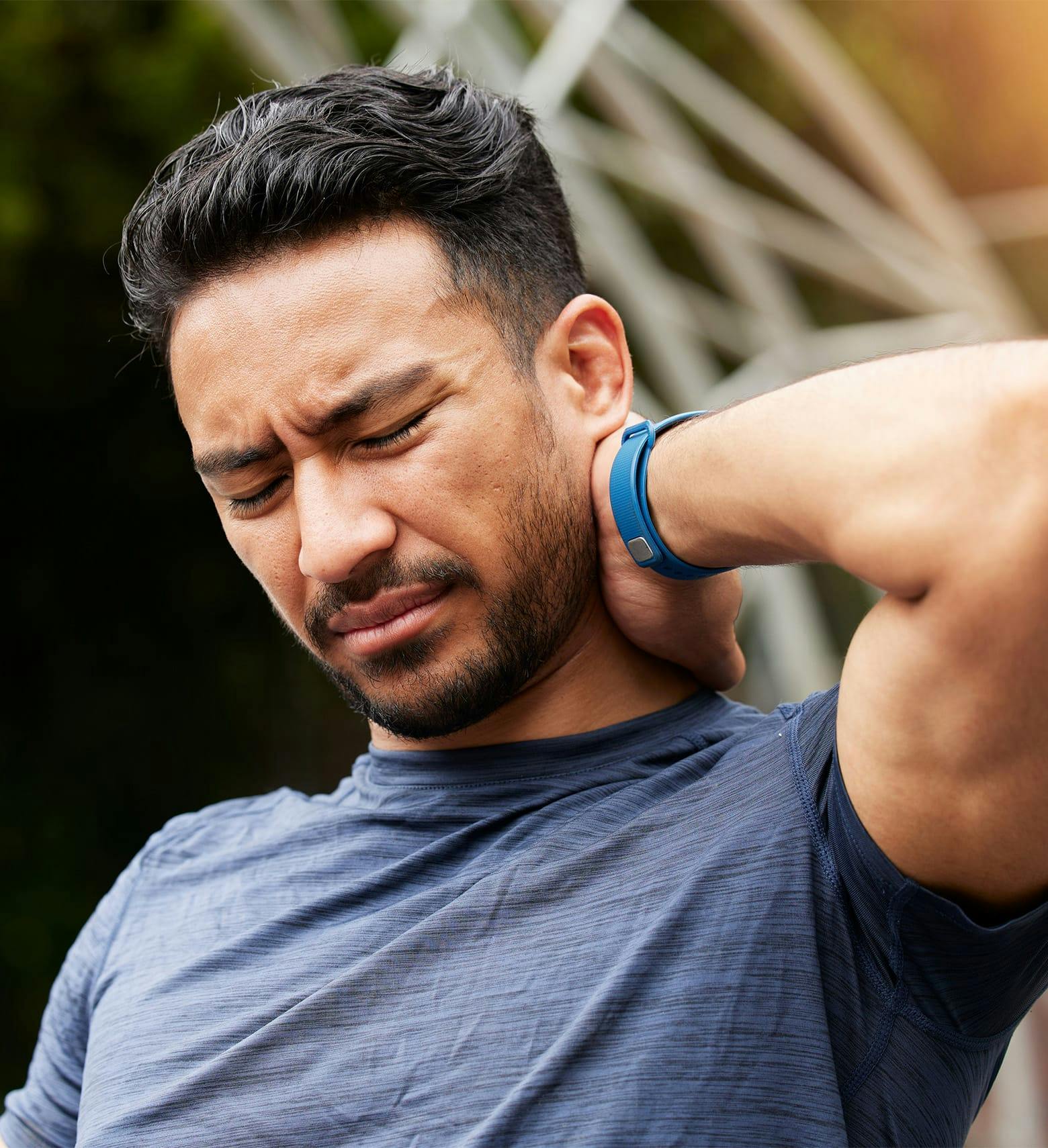 man holding his neck in pain