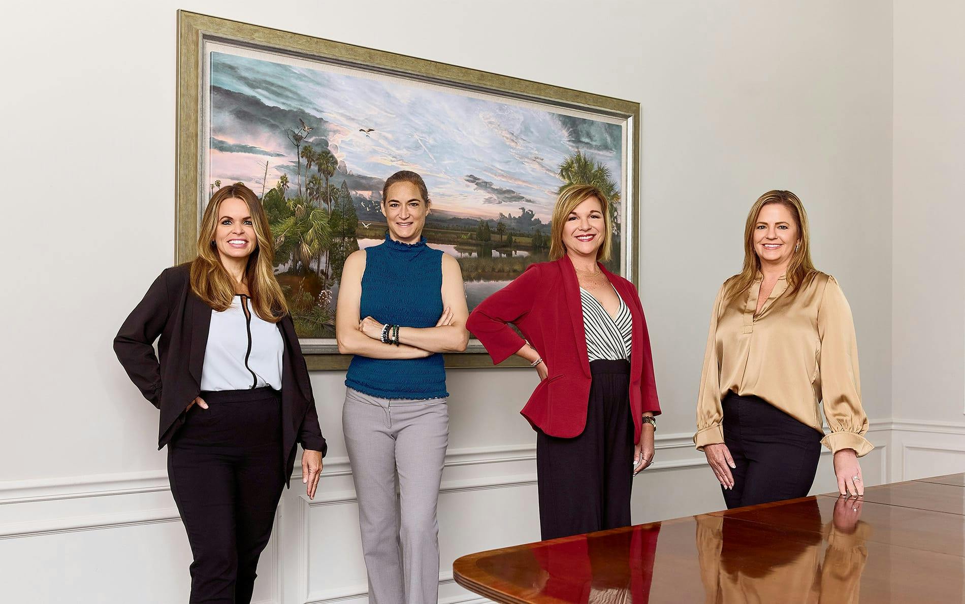 four women standing in front of a table