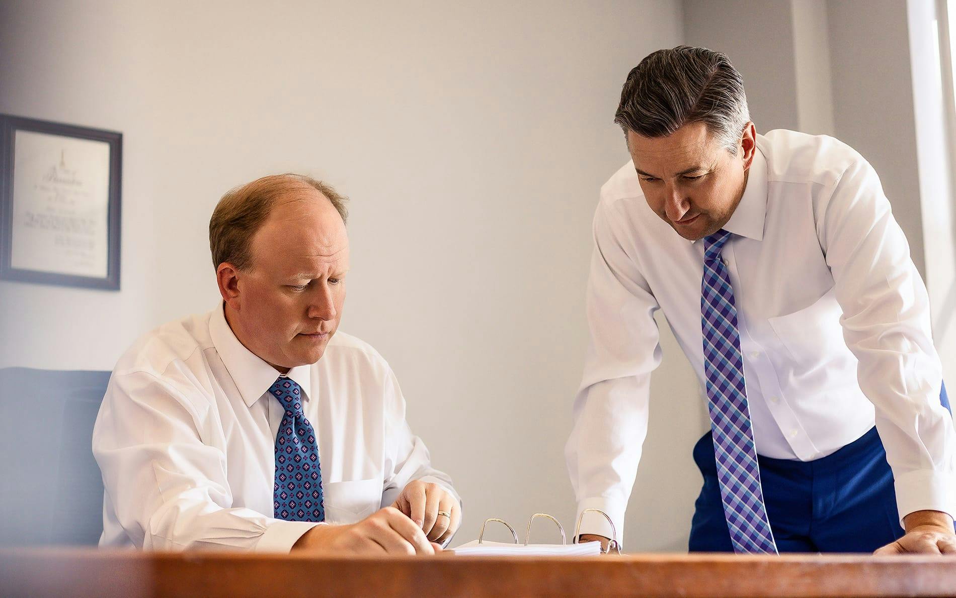 two men looking at paperwork
