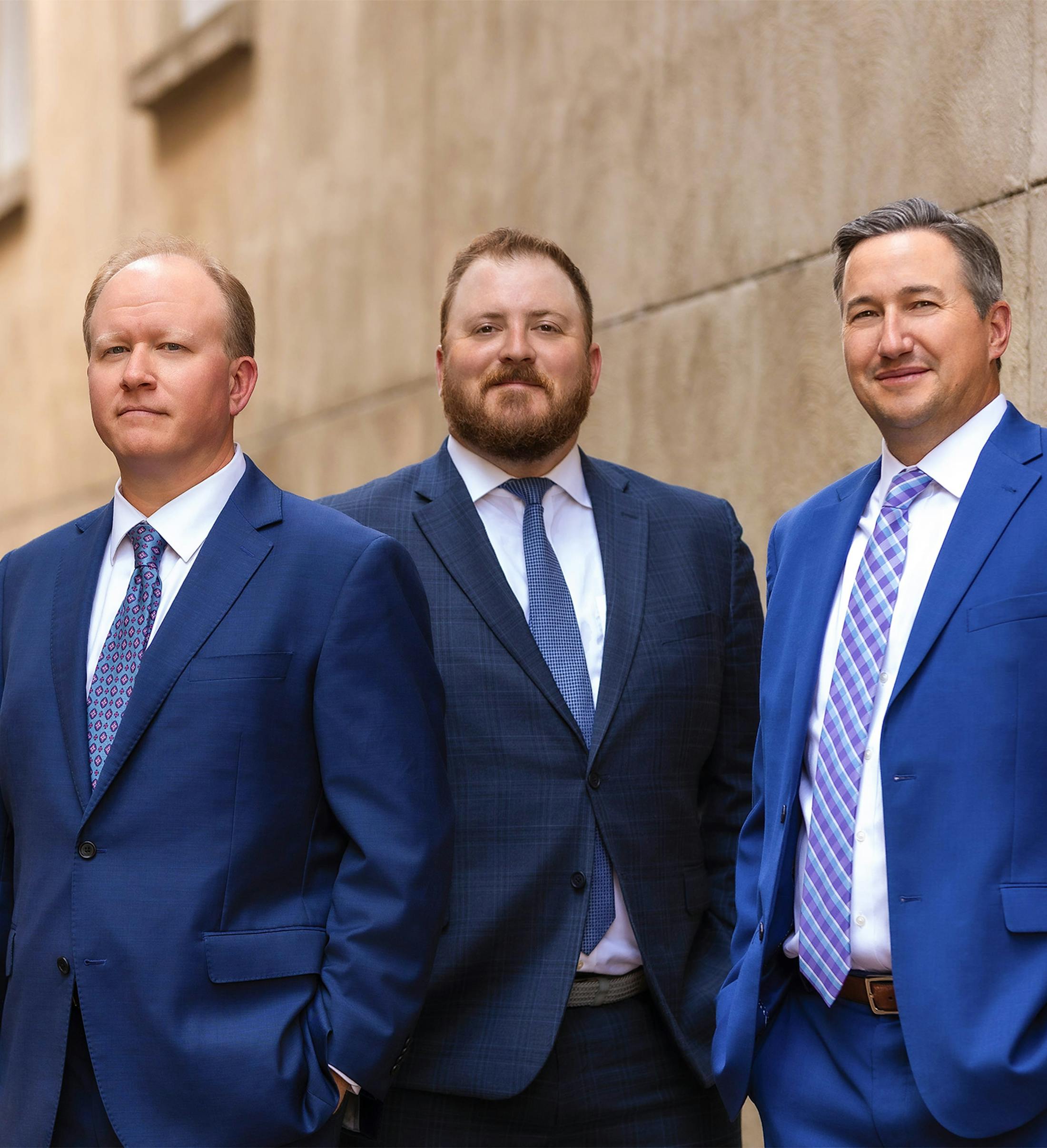 three attorneys standing outside