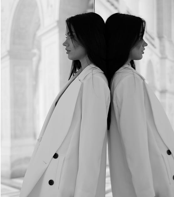 Black and white image of a woman in a coat