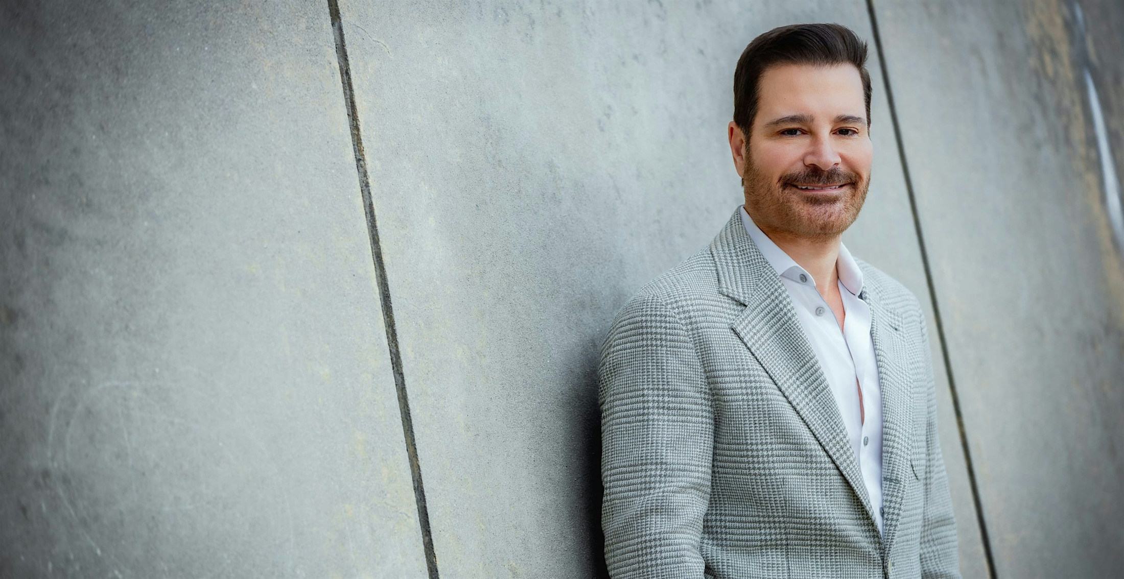 Dr. Vartanian in a suit against a wall