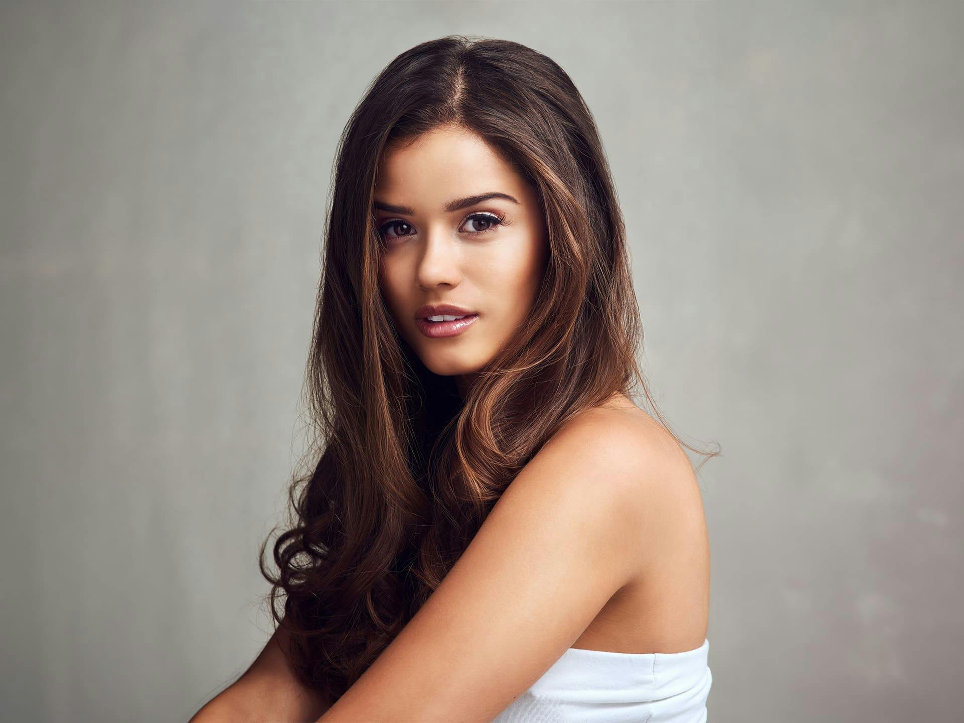 woman with white strapless top and long brunette hair