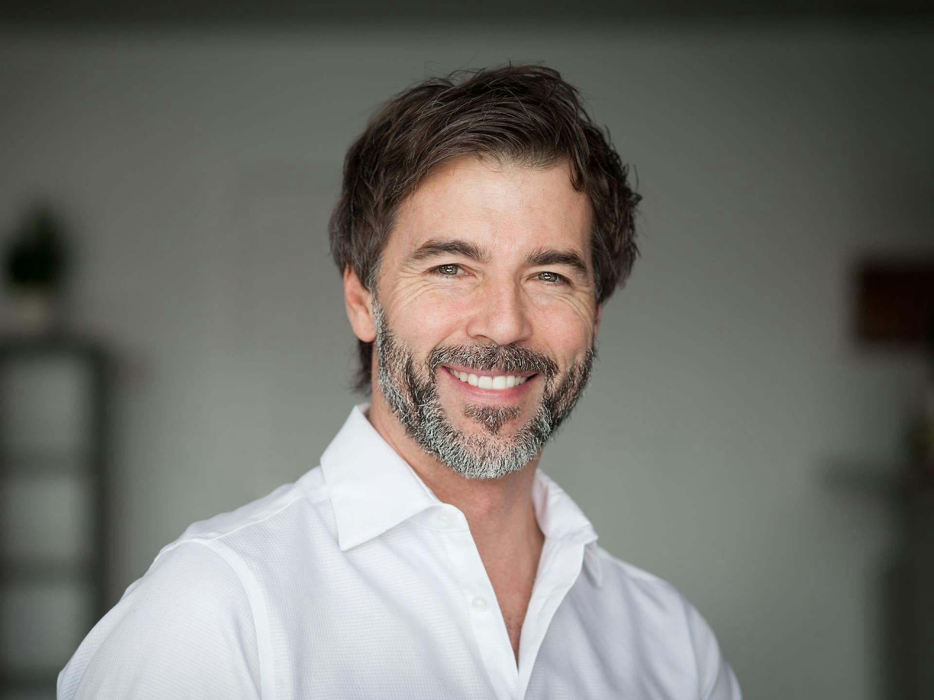 man with a beard smiling