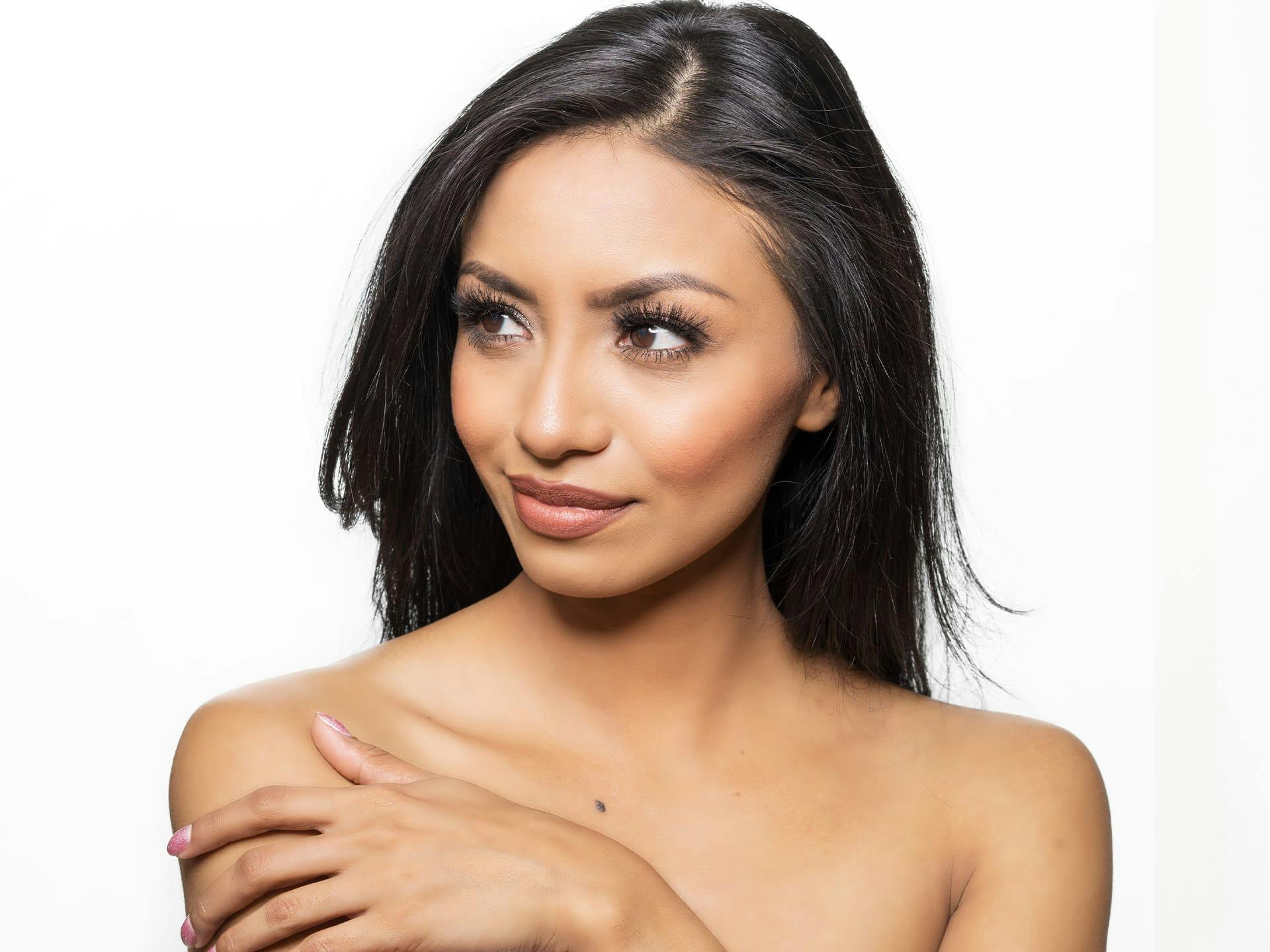 woman looking to the left with her hand on her shoulder