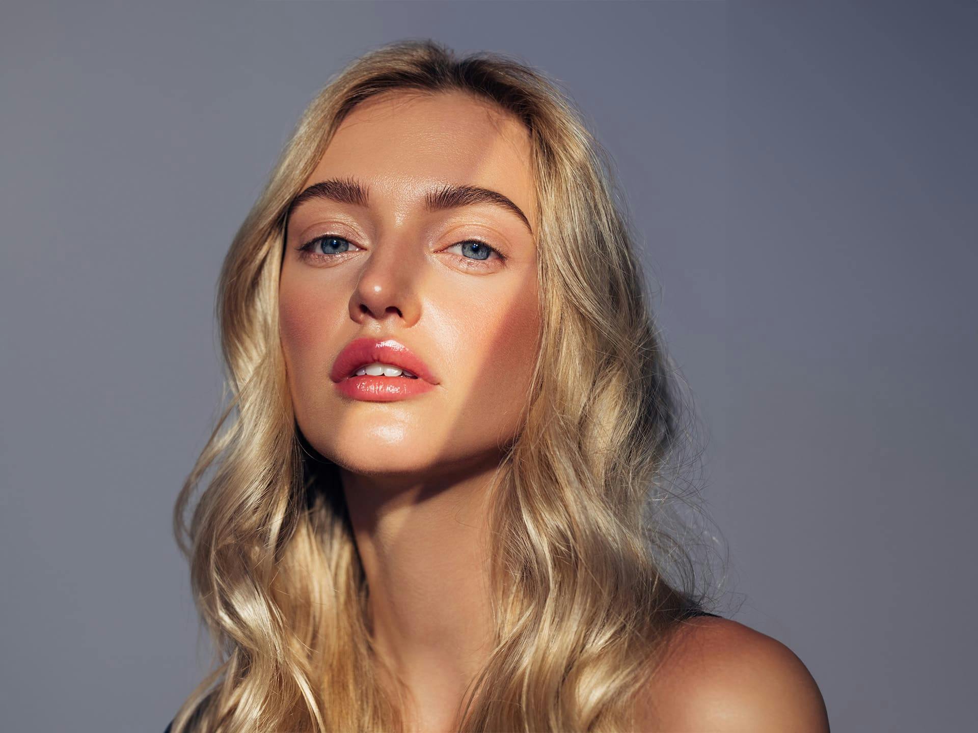 blonde woman with purple background