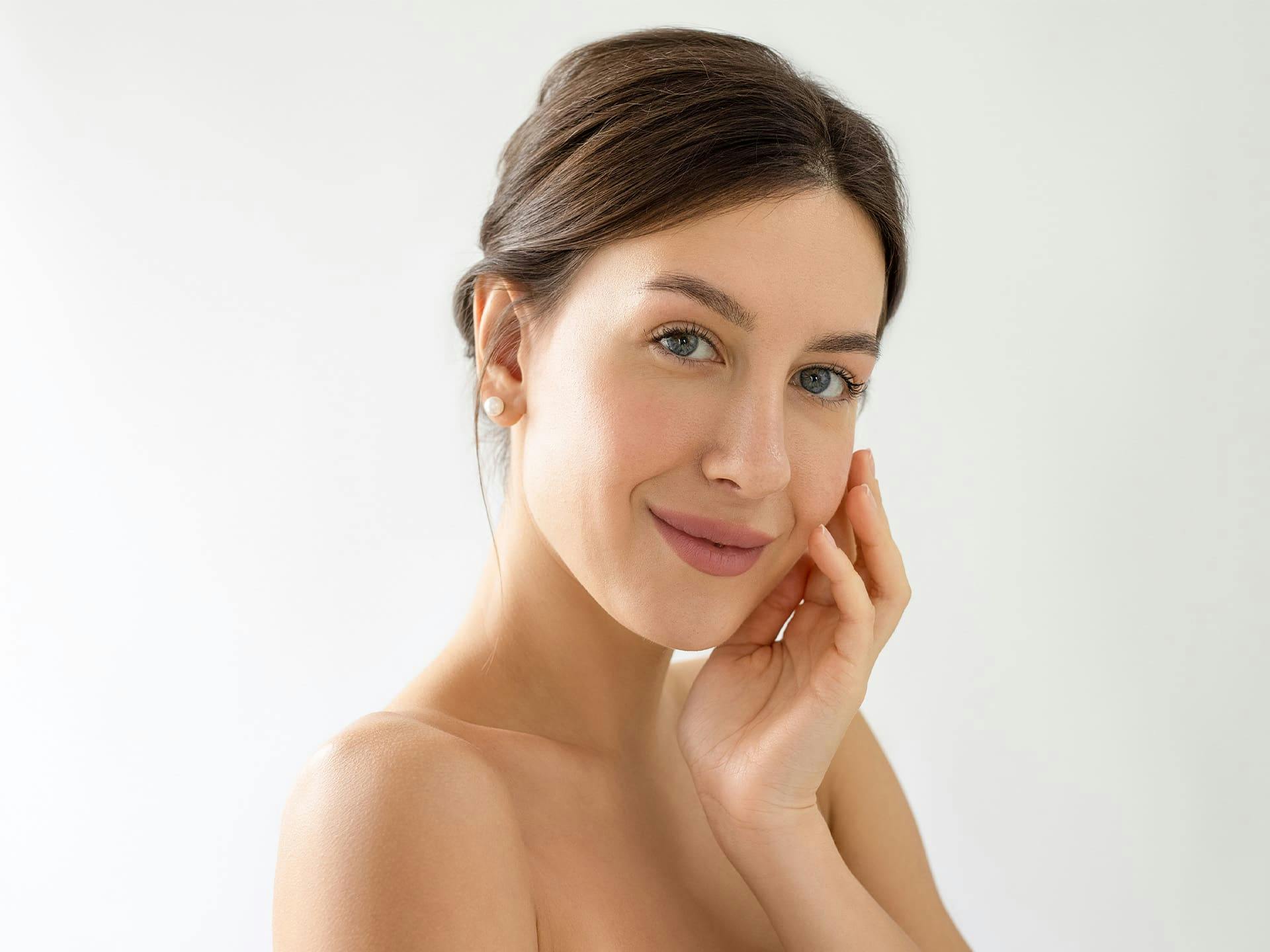 woman smiling with her hand on her cheek