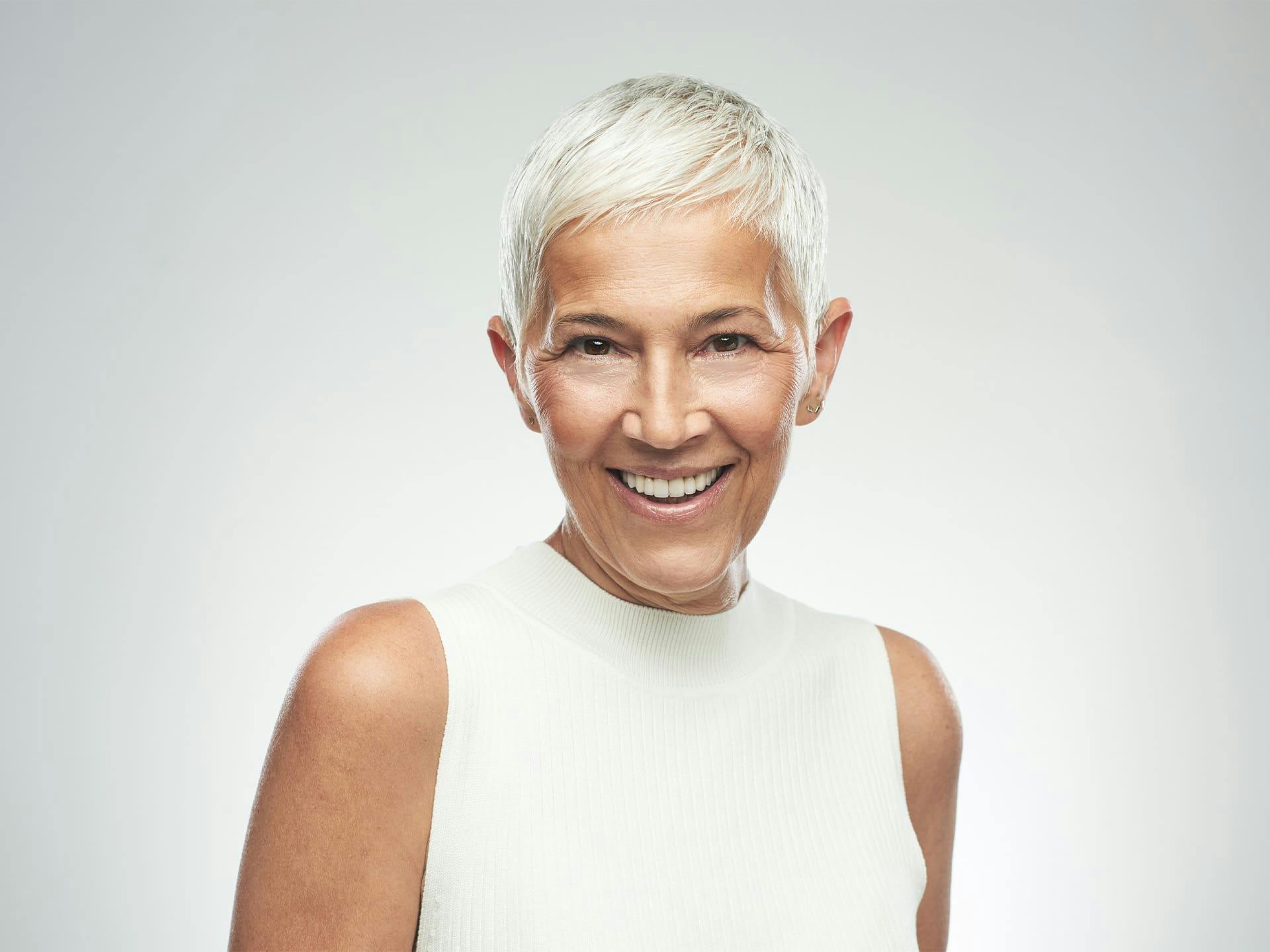woman with pixie hair cut smiling