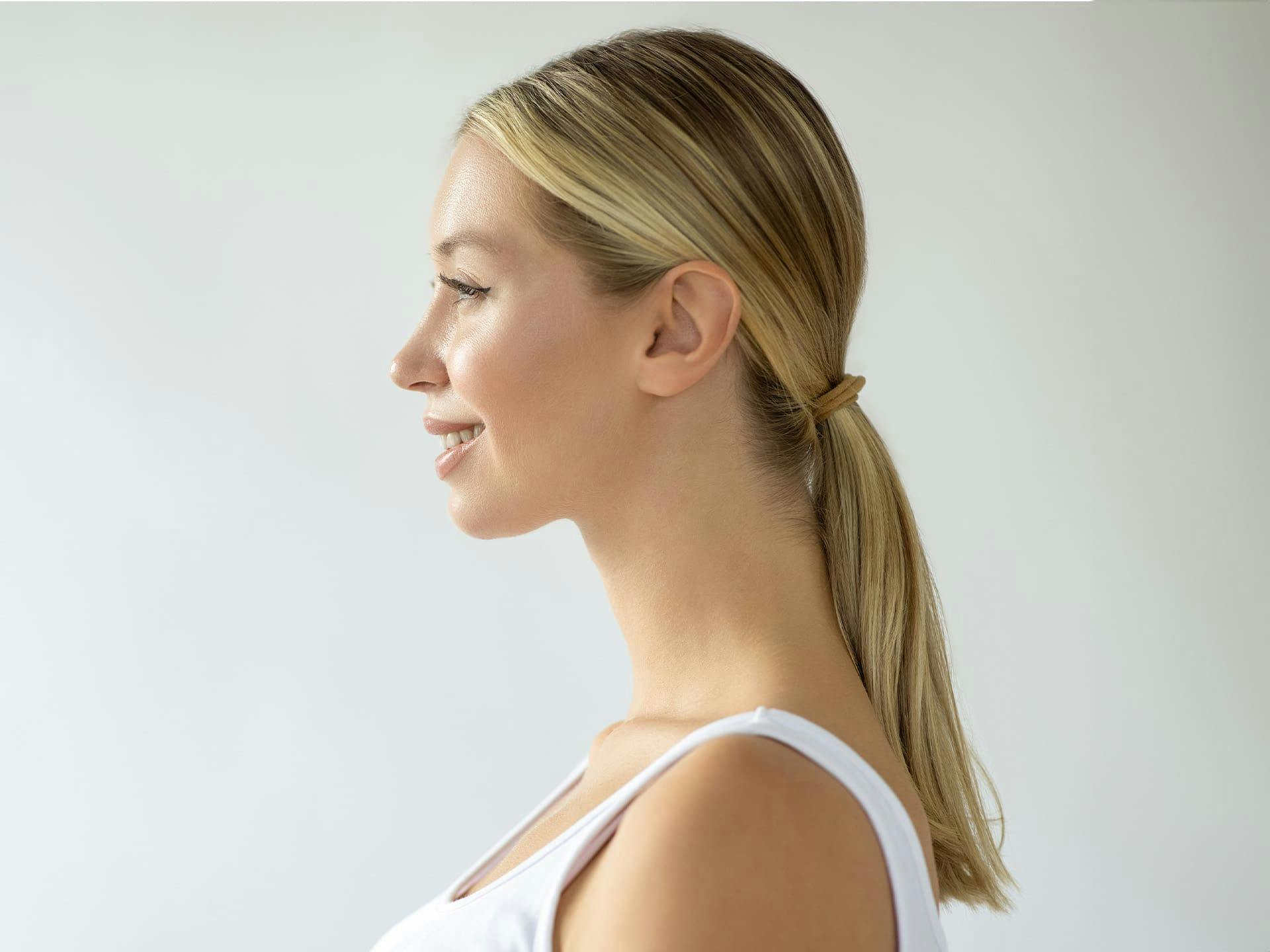 side profile of blonde woman with low ponytail