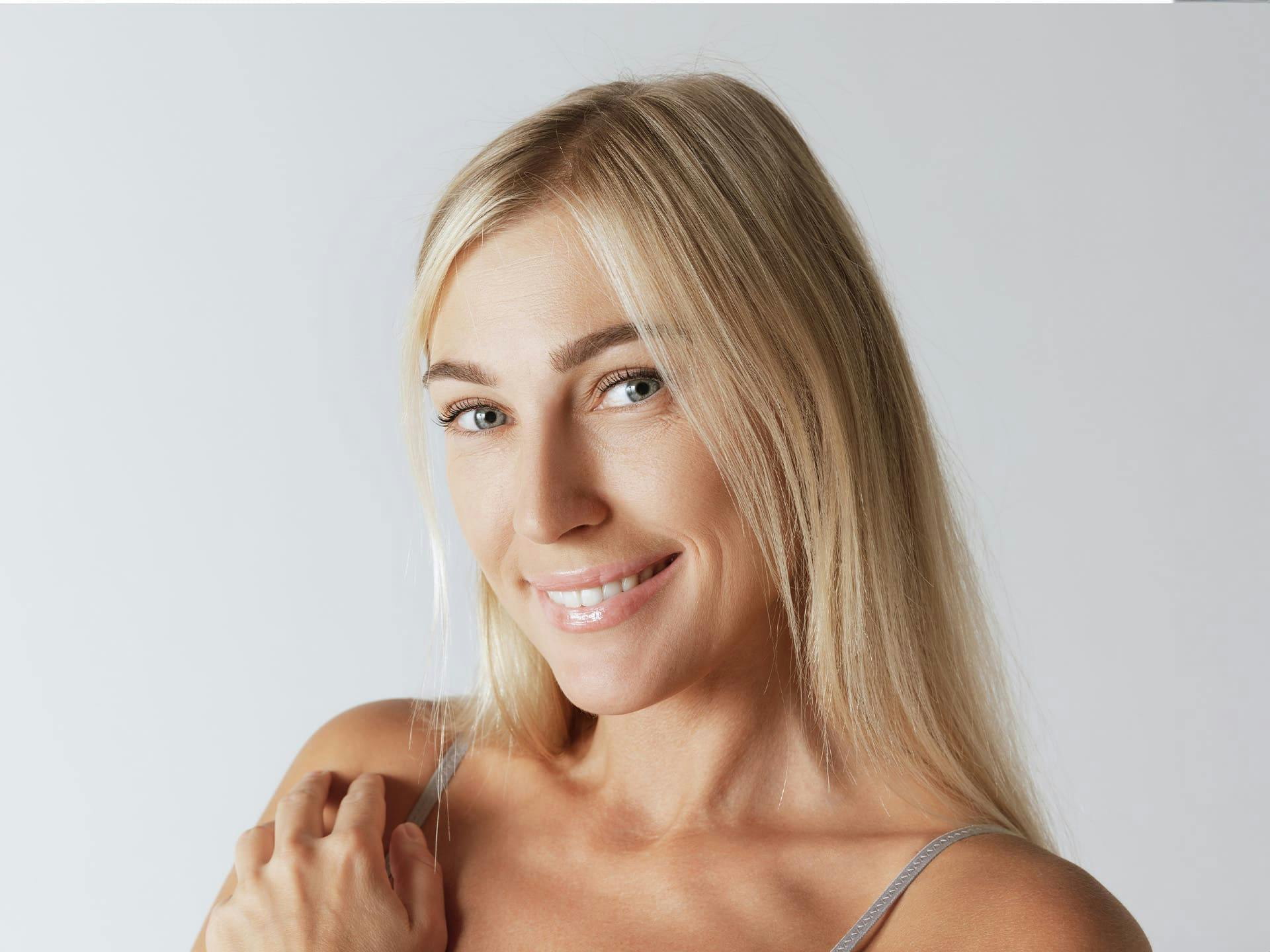 woman with straight blonde hair smiling