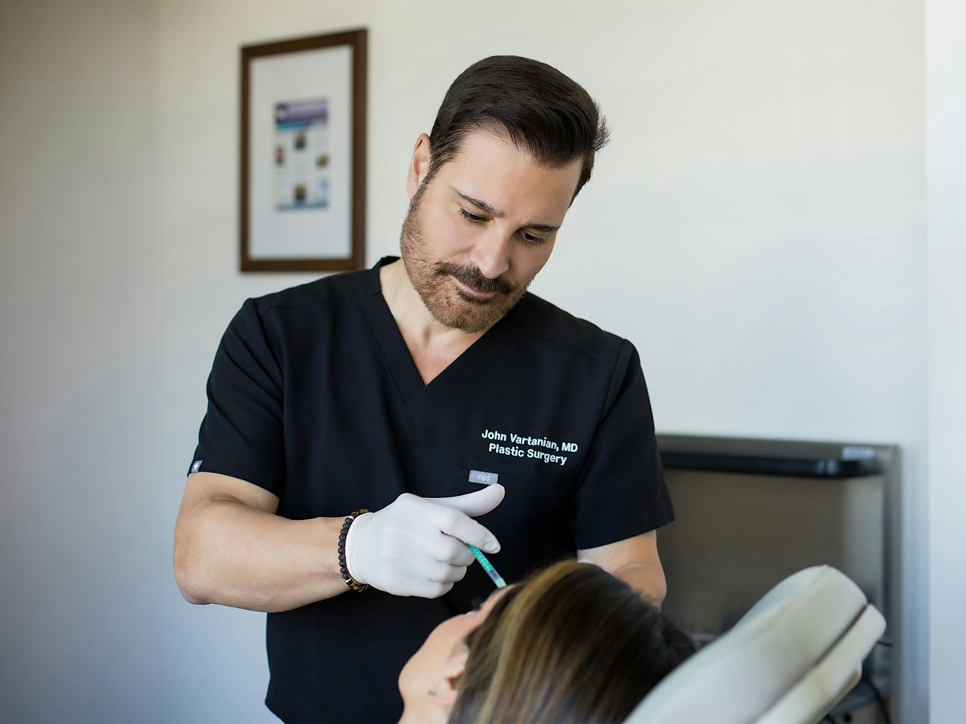 Dr. John Vartanian giving female patient injections