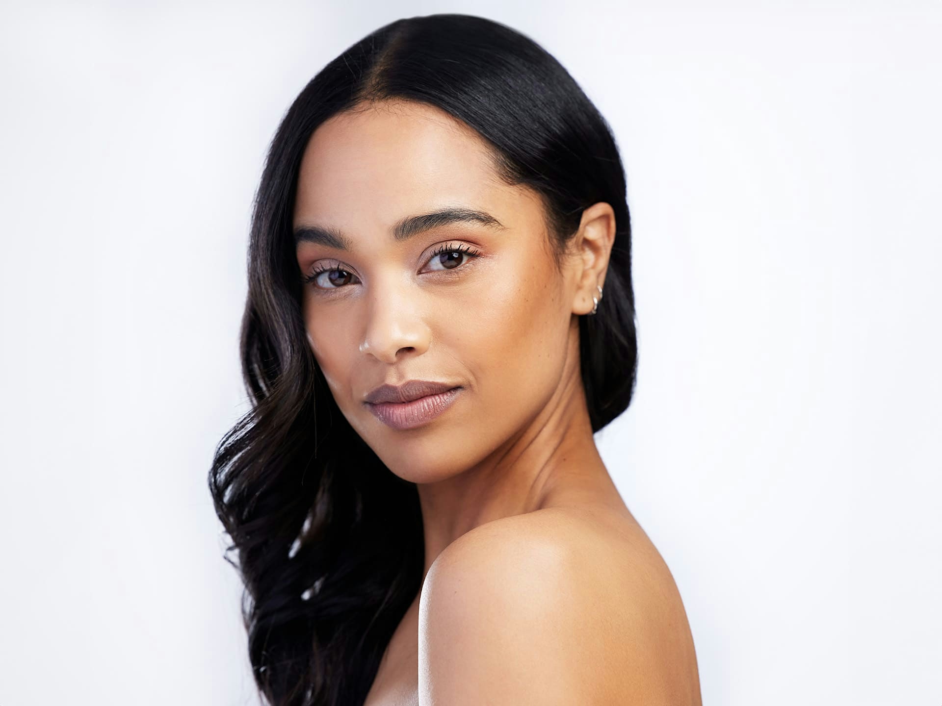 woman looking over her shoulder with her hair thrown to one side