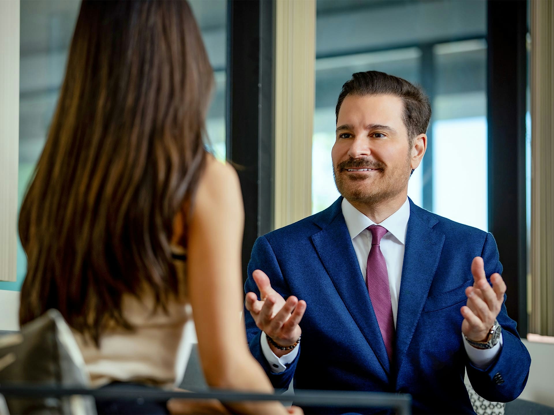 Dr. John Vartaian speaking with female patient