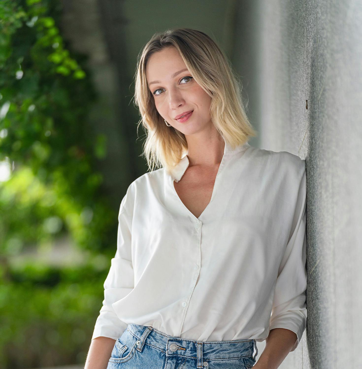 Woman leaning against wall smiling