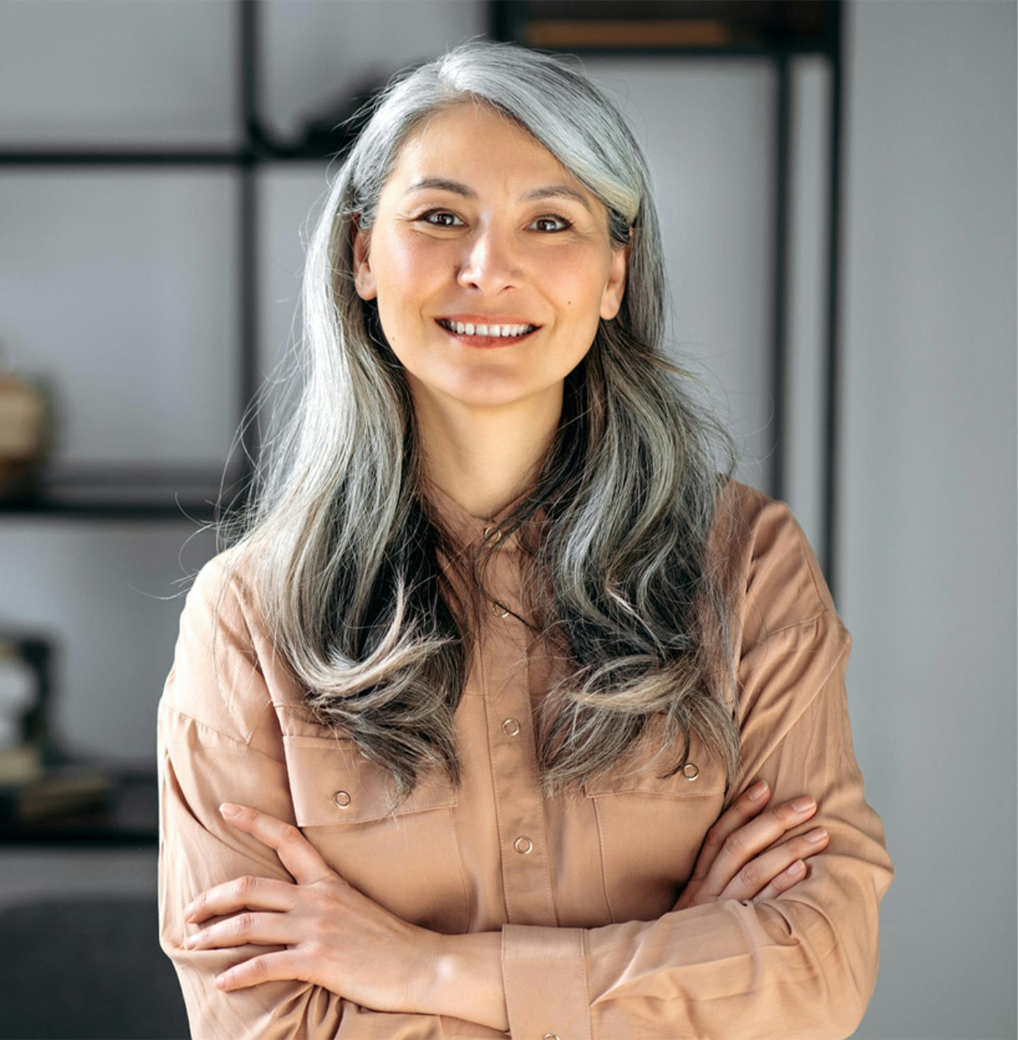 Woman with arms crossed smiling