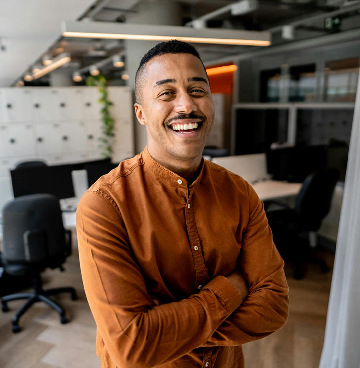 Man smiling with arms crossed